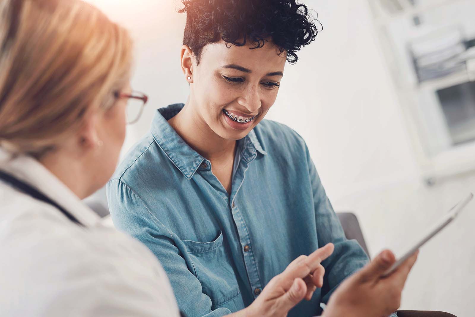 Ask the orthodontist plenty of questions at your initial consultation patient talking with her orthodontist