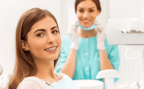 woman wearing braces in orthodontist chair