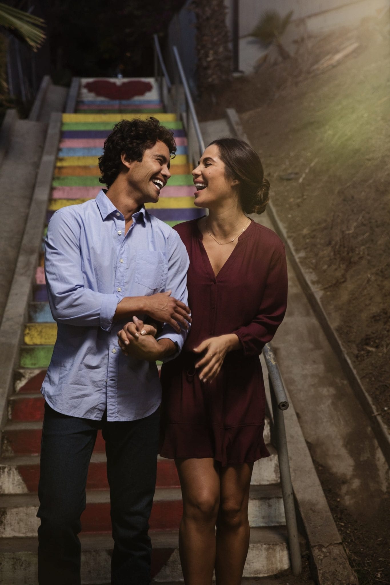 Happy couple walking down stairs Invisalign