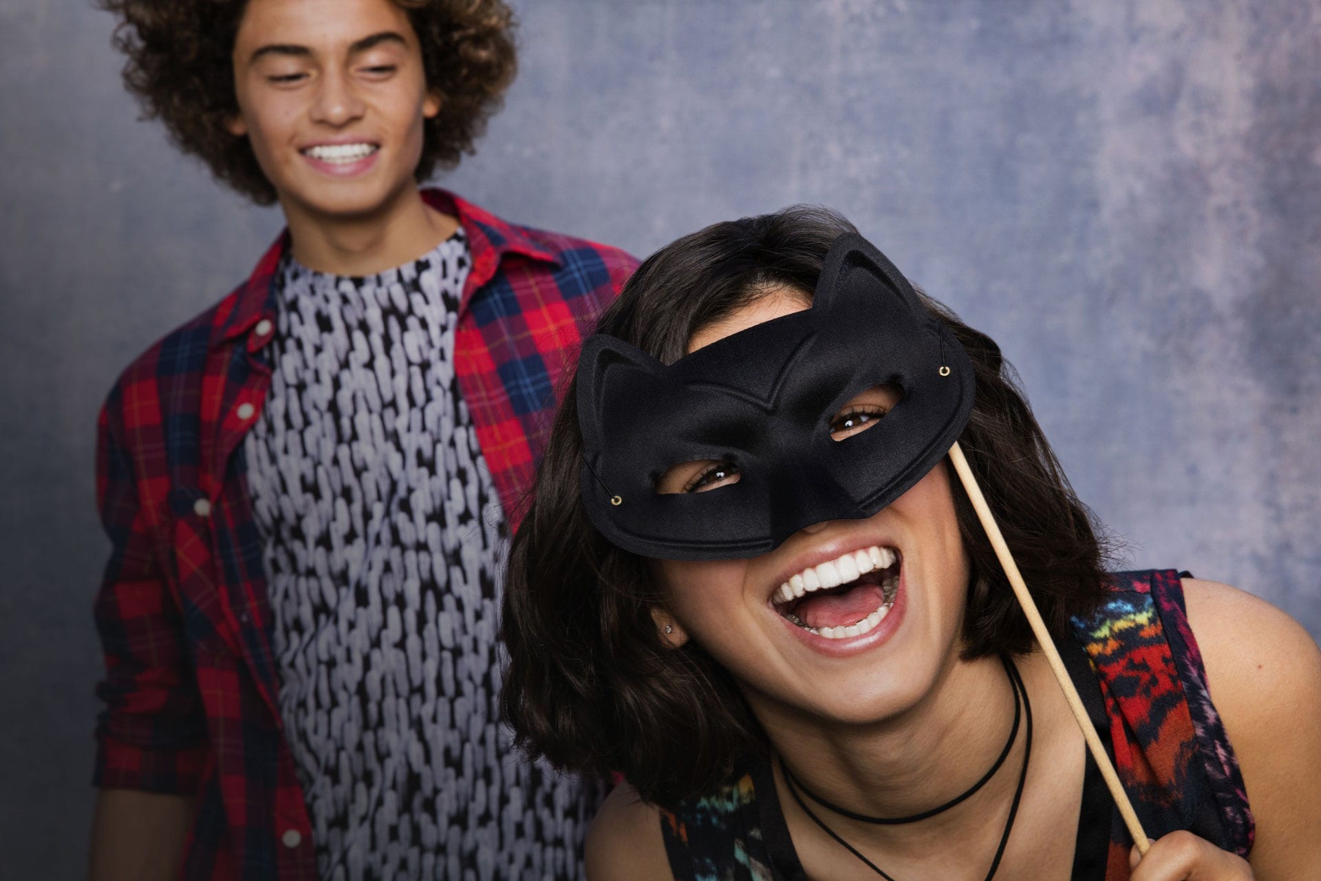 teens in a photo booth with mask wearing Invisalign Teen aligners