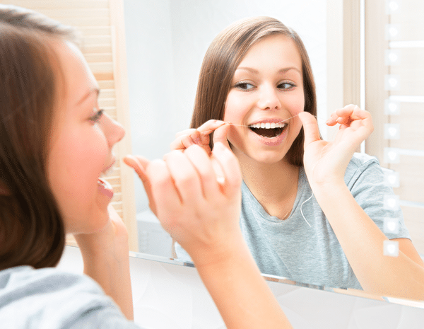 teen girl flossing, Sacramento, CA