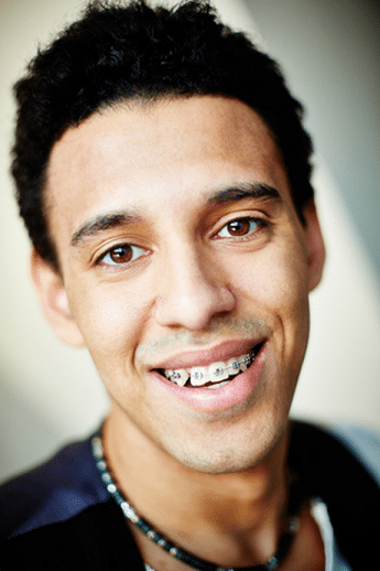 close up of stylish young man wearing braces