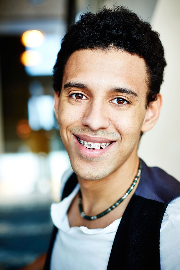 stylish teen boy wearing braces
