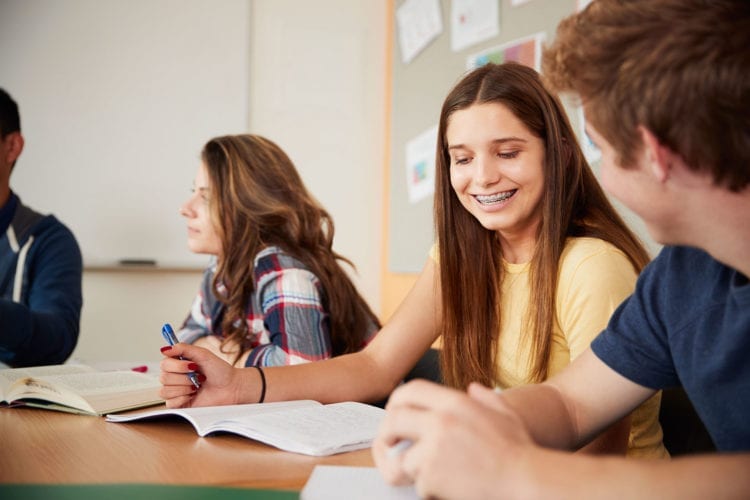 high school students sitting at table