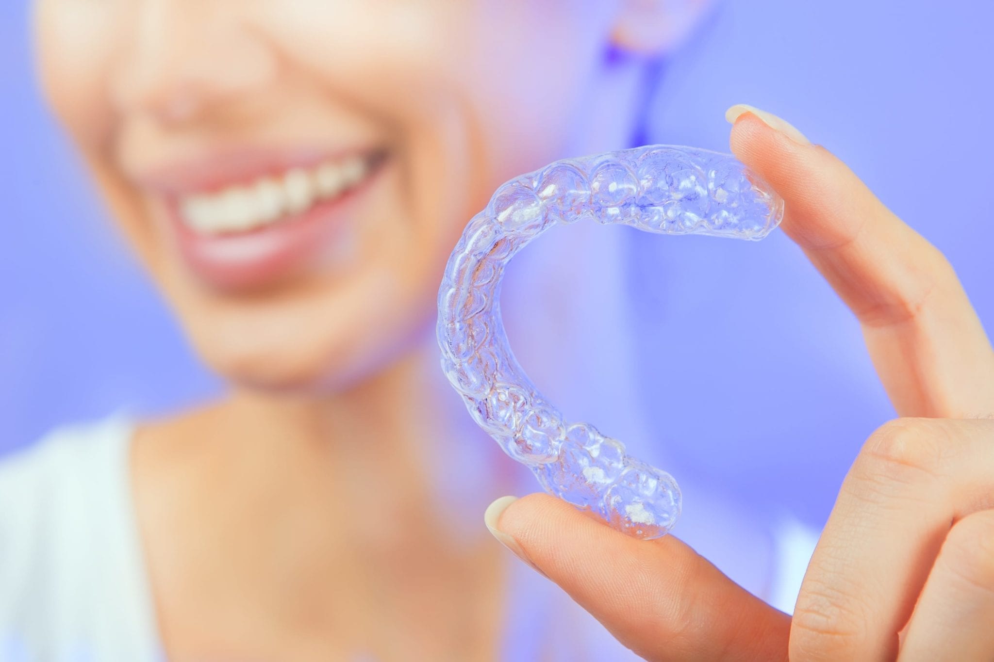 Closeup of woman holding a clear aligner, Sacramento, CA