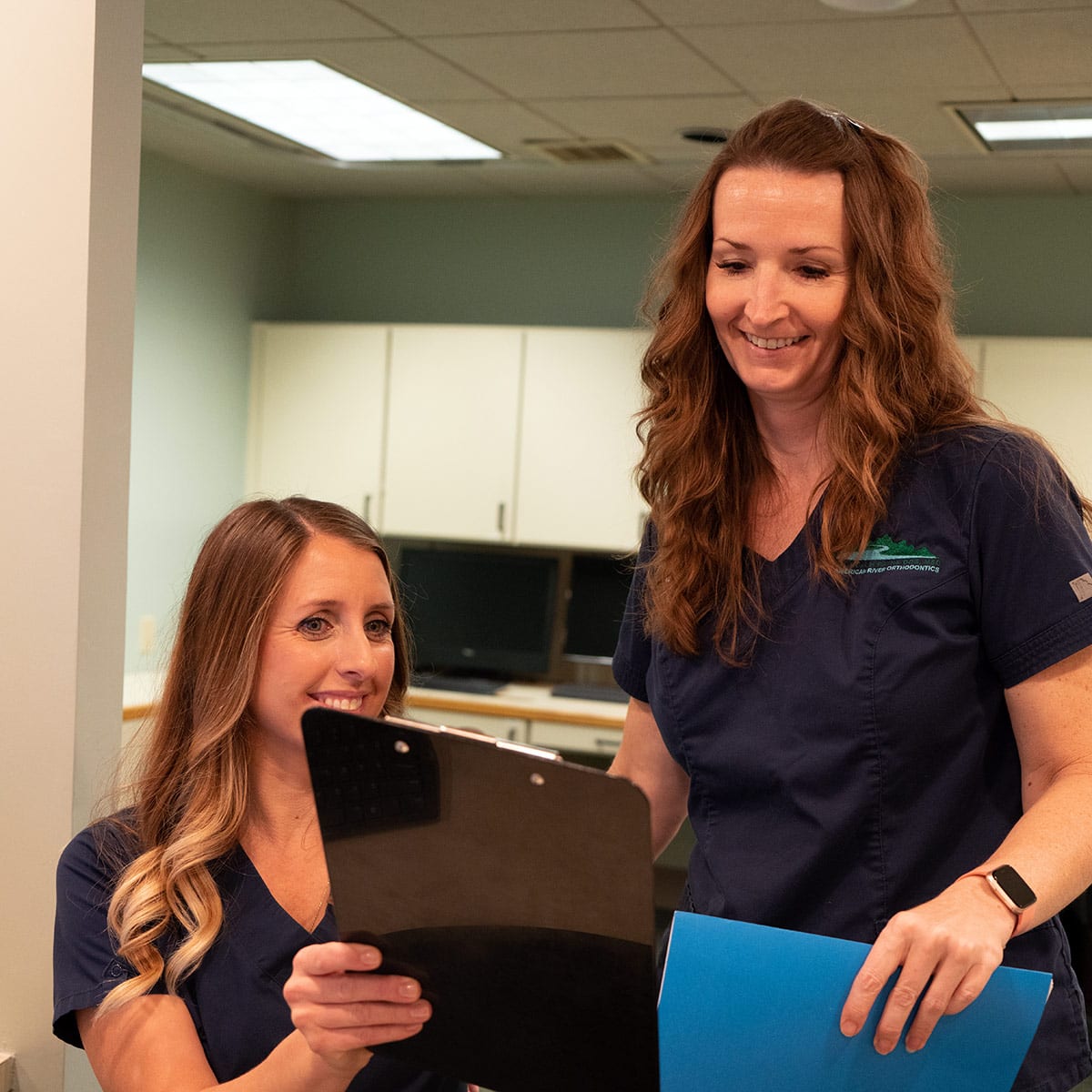 Shannon and Cheryl check in a new patient for a free consultation for orthodontic treatment