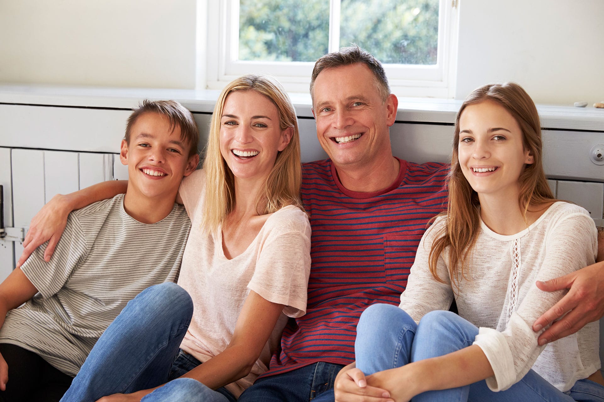 Family with beautiful smiles relaxing at home