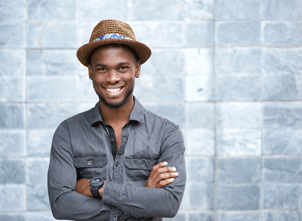young man wearing a hat and smiling