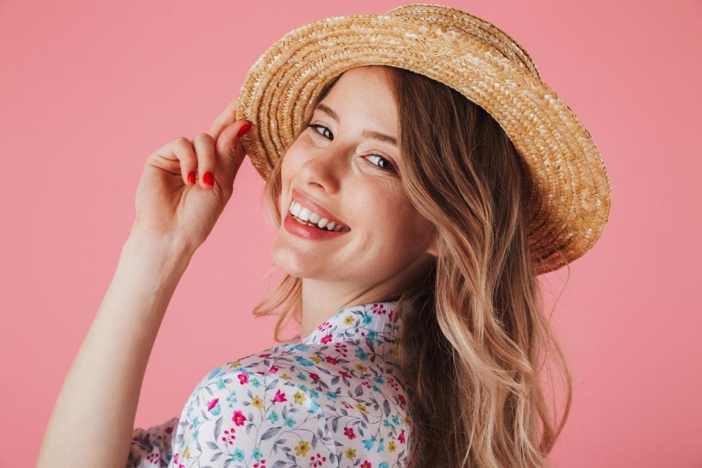 portrait of smiling young woman in a hat