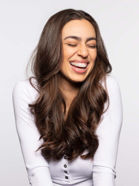 Woman excited to smile while wearing LightForce braces