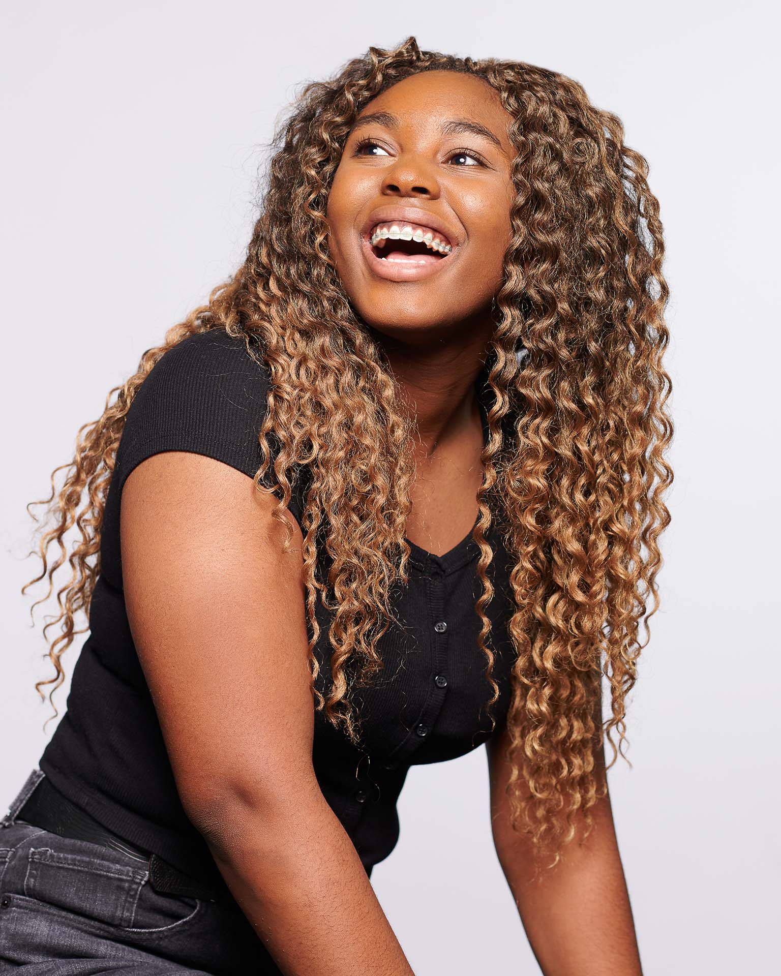 Sacramento woman smiling with clear braces on her teeth