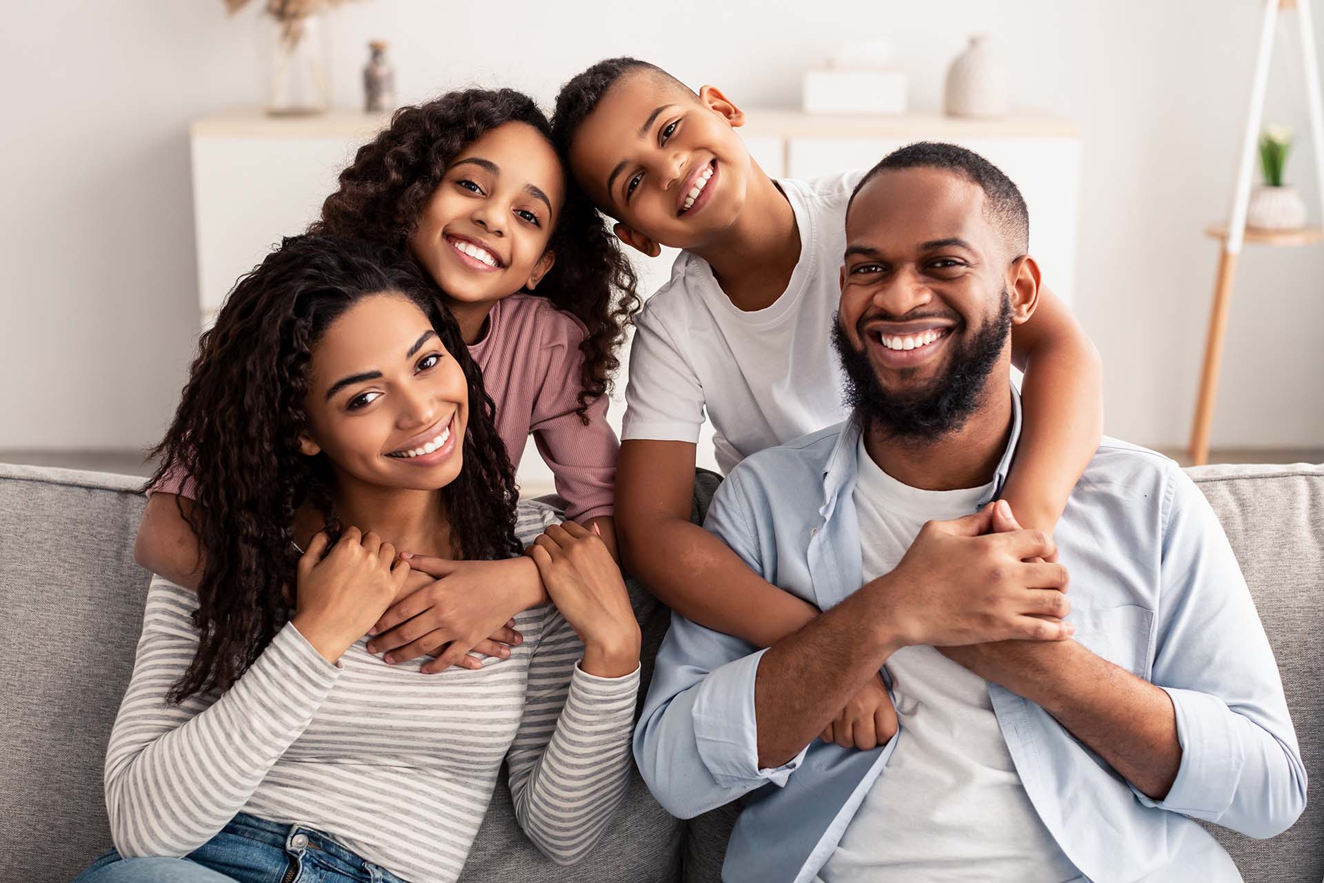 Mom, Dad, son & daughter all showing off their gorgeous smiles after straightening their teeth