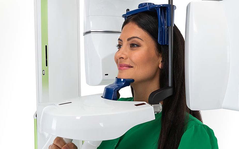 Woman getting 3D X-ray scan to check bone density prior to ceramic braces at American River Orthodontics near Land Park, Sacramento, CA