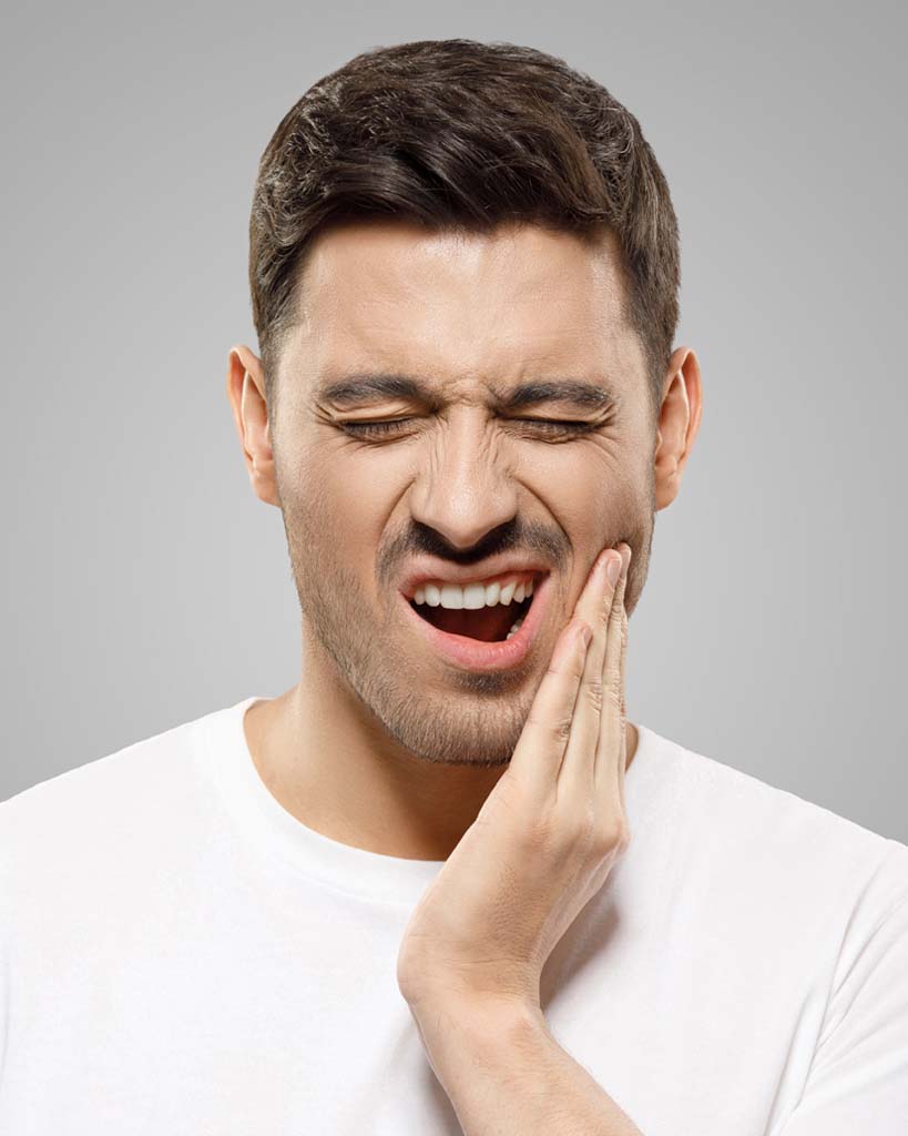 Man experiencing jaw pain in his TMJ