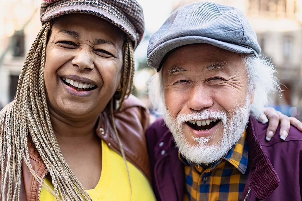Senior couple smiling outside the family orthodontic office after an appointment Senior couple smiling outside the family orthodontic office after an appointment