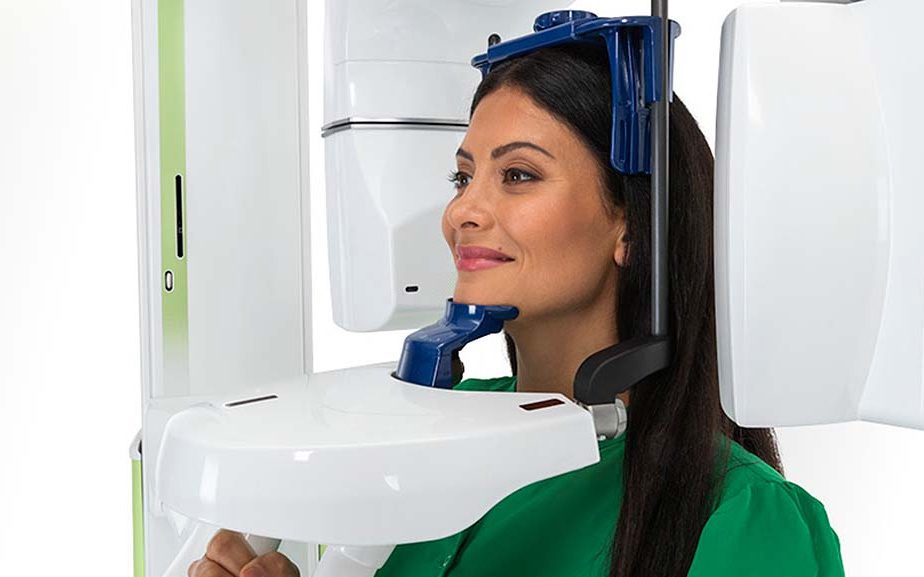 Woman getting a 3D x-ray scan to see the density of bone for ideal treatment with ceramic brackets at American River Orthodontics near Carmichael Woman getting 3D X-ray scan to check bone density at American River Orthodontics near Carmichael, CA