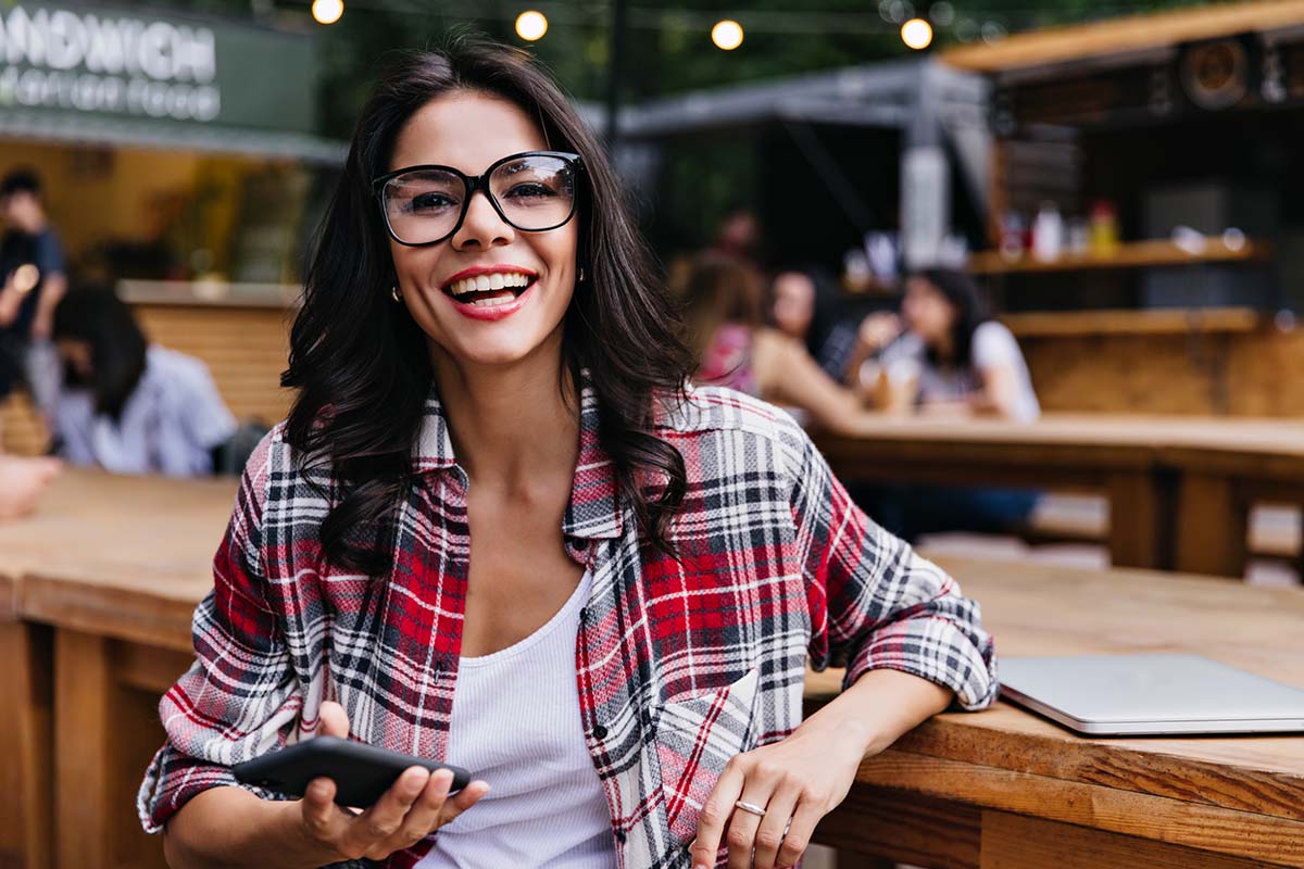 Woman reading current orthodontist reviews and yelp reviews searching for the best orthodontist in East Sacramento