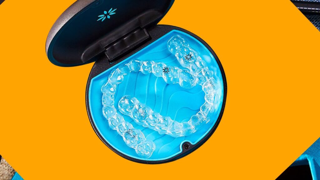 Clear Invisalign aligners in a carrying case.  Learn about the average cost of Invisalign treatment and financing options.