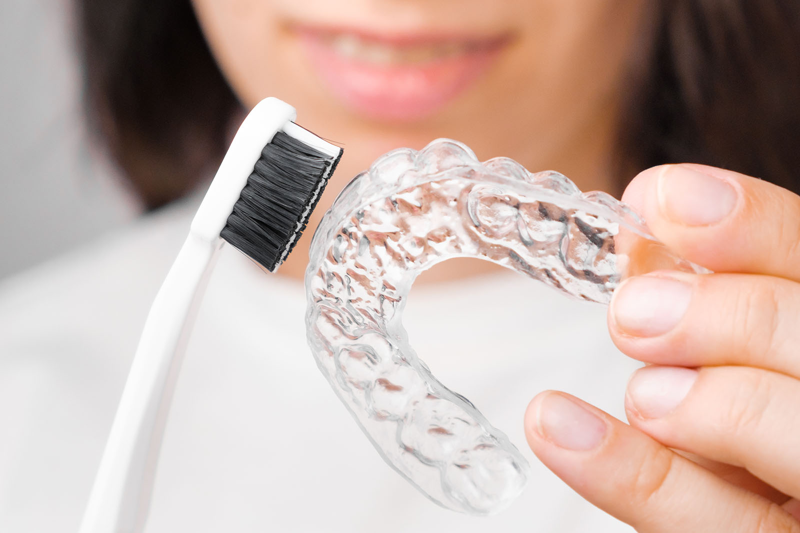 cleaning Invisalign clear aligners with a toothbrush