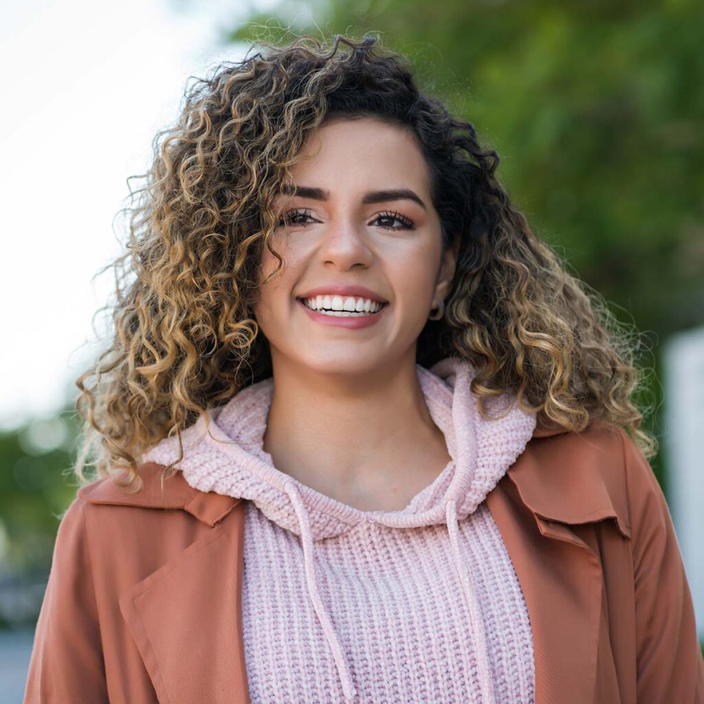smiling woman in Sacramento showing off her new smile