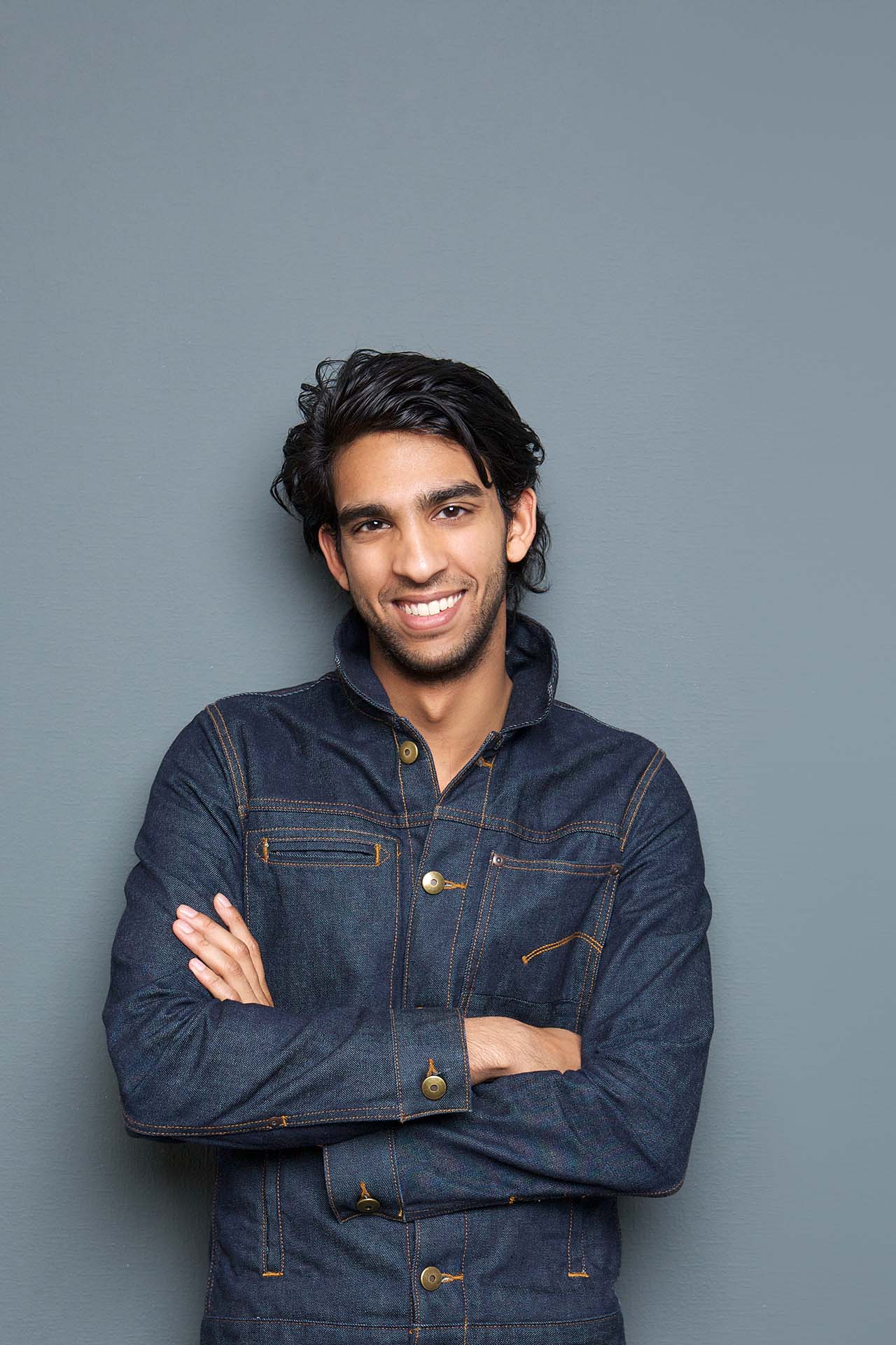 Stylish young man straightens his teeth with clear aligners