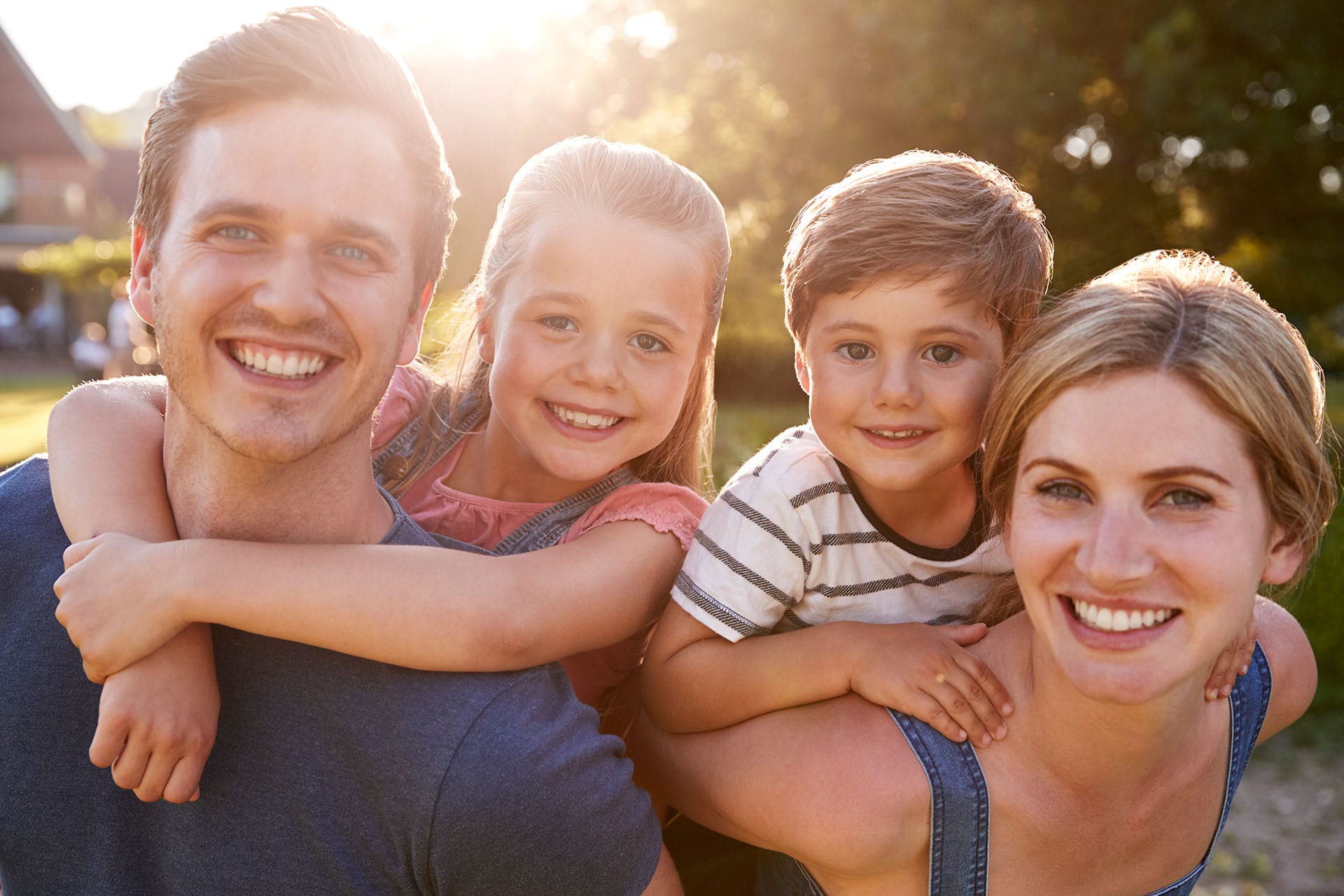 smiling family outdoors in summer