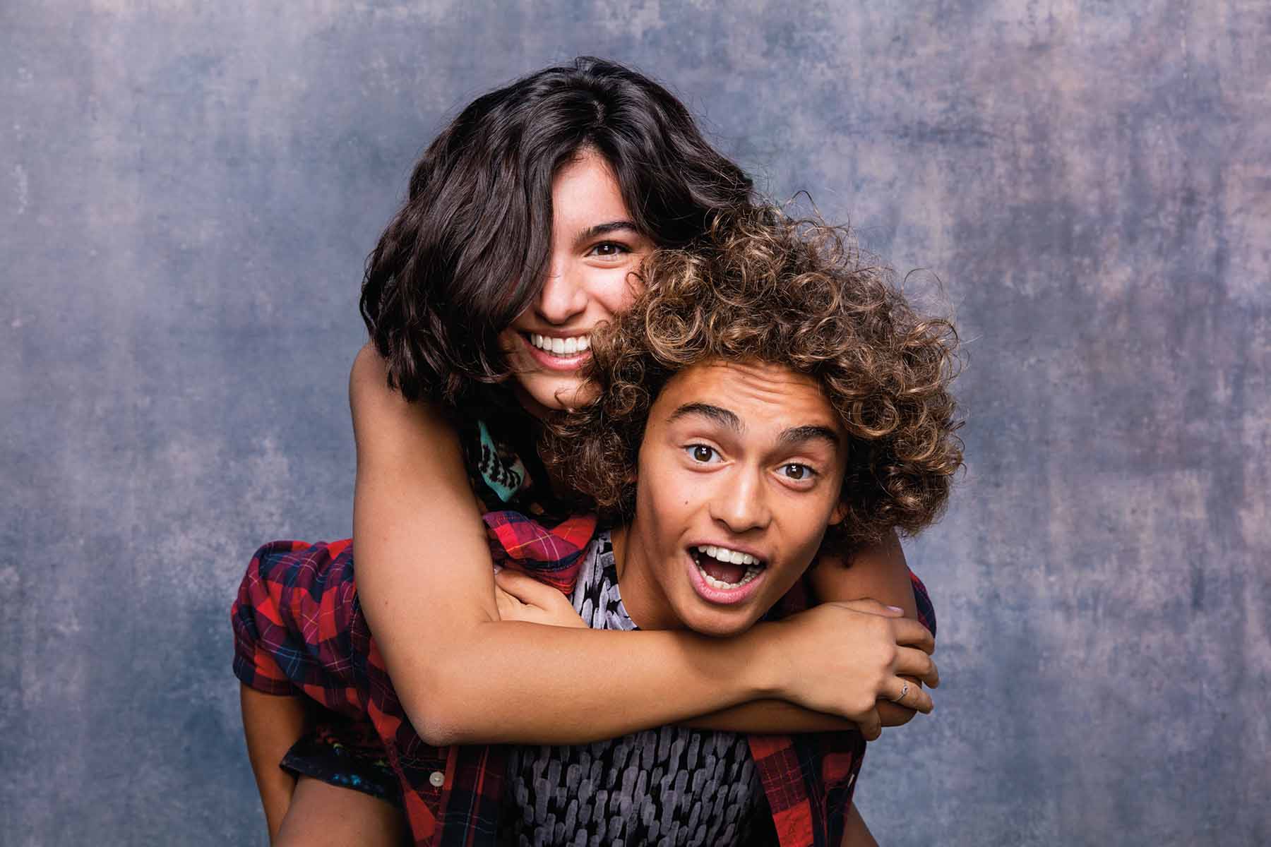 American River Orthodontics is a provider of Invisalign® Teen Smiling teen couple posing in a photo booth