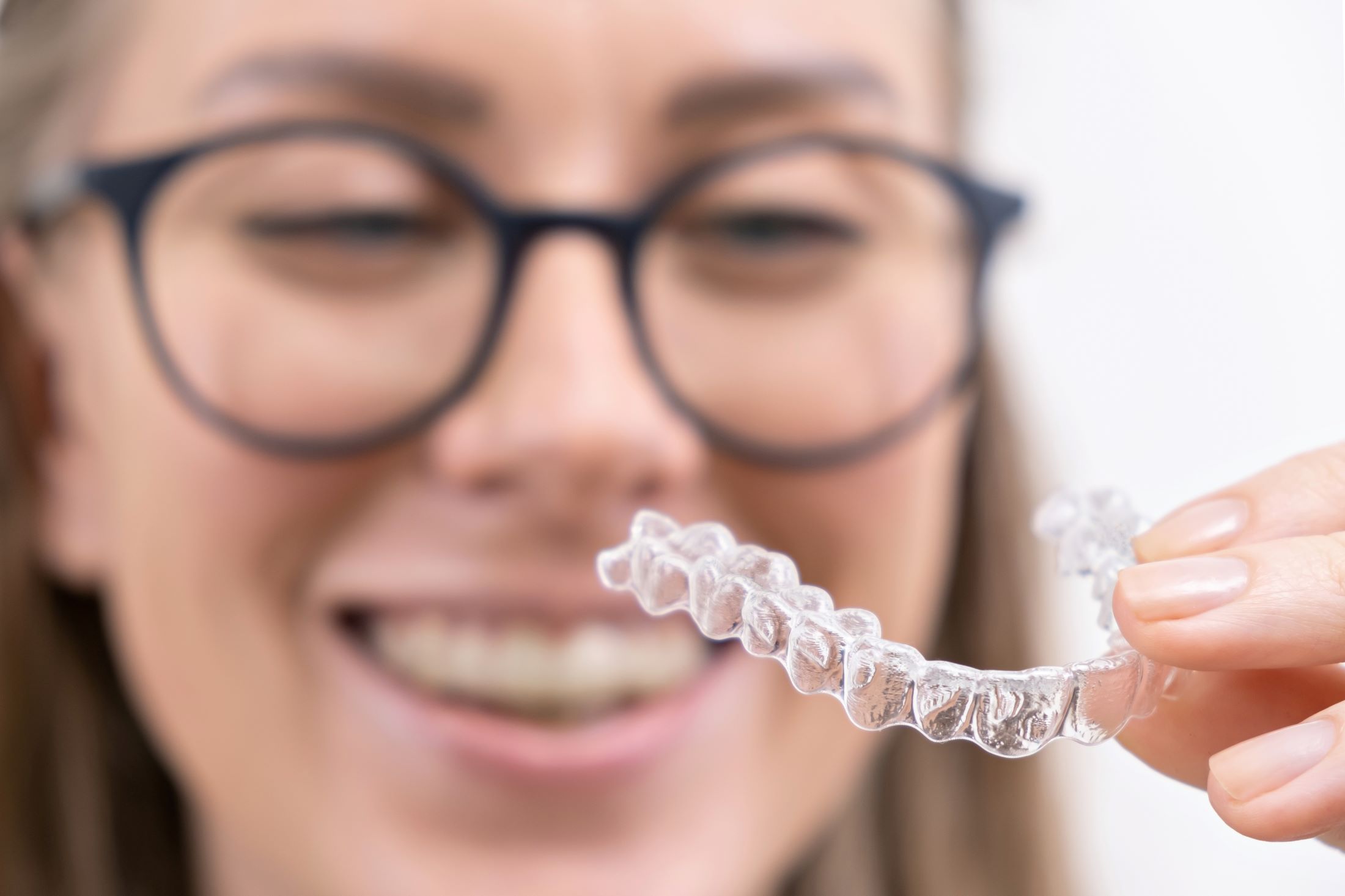 smiling-woman-using-clear-plastic-removable-braces-2024-12-05-13-20-03-utc