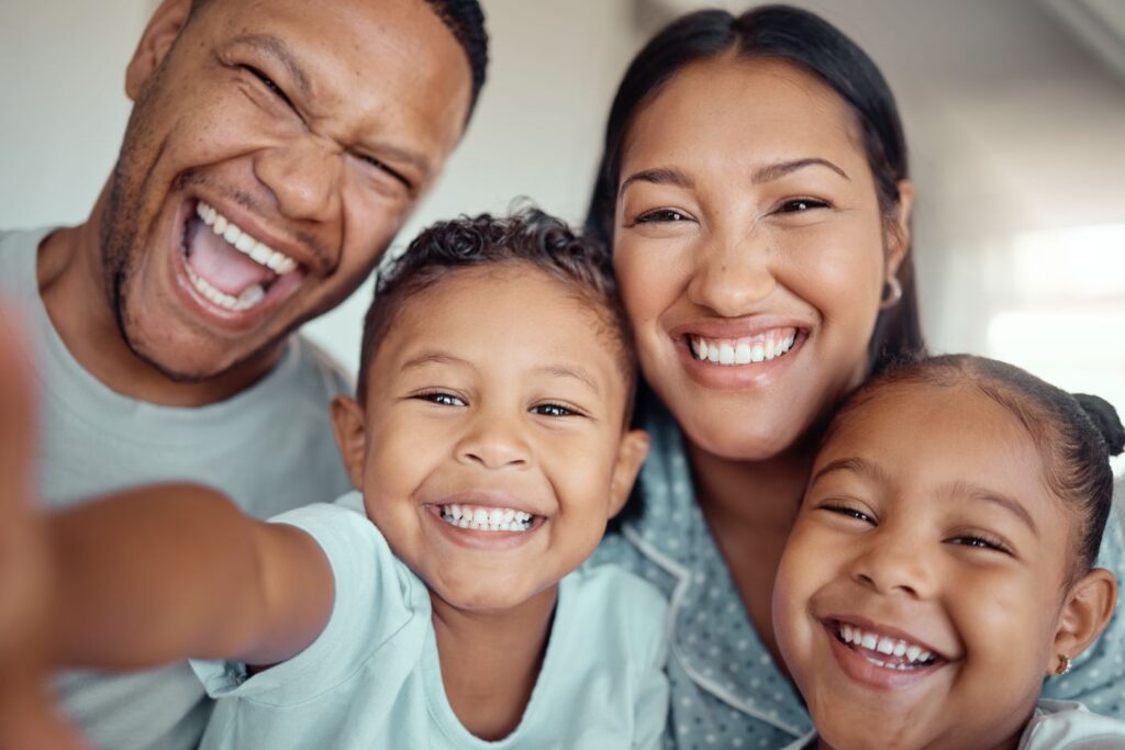 A family happy because they have health insurance and their dental insurance covers orthodontics