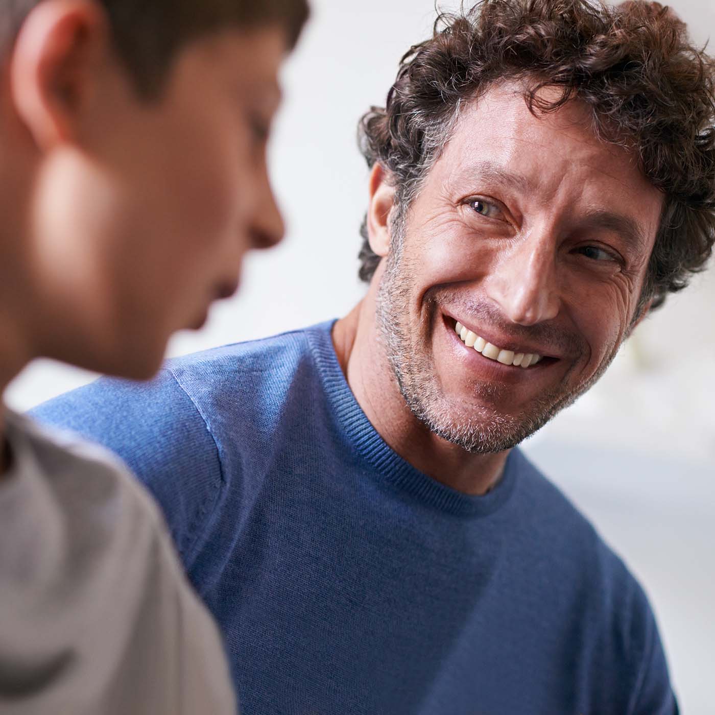 dad enjoys spending time with his teenage son Dad and teenage son bonding, reflecting the peace of mind from flexible orthodontic payment options.